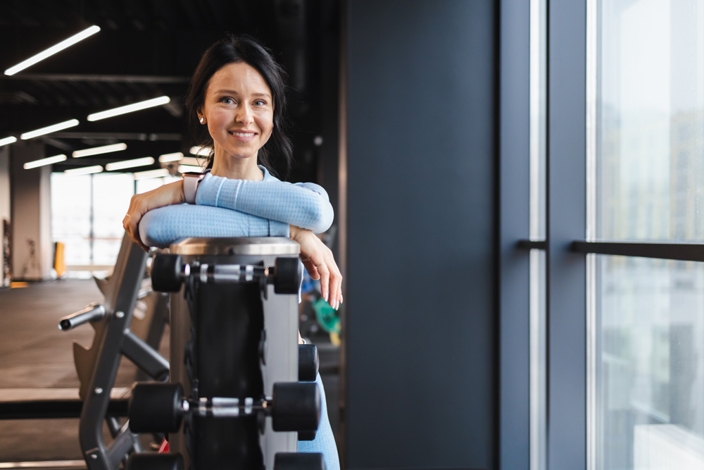 Portrait of a cheerful fitness trainer in the gym